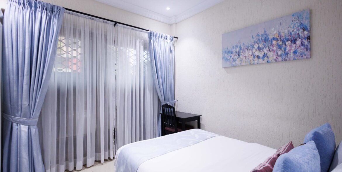 Economy Double Room beside a curtained window