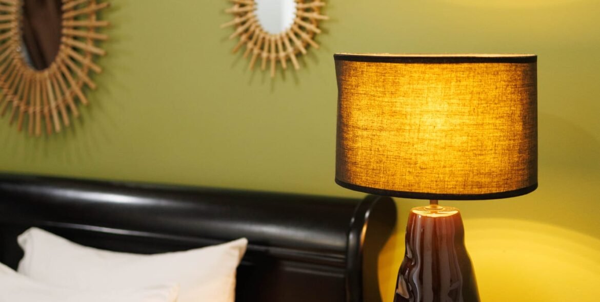 Bedside lamp against a green accent wall