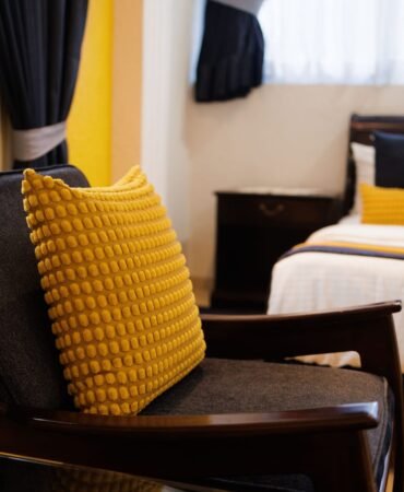 Armchair beside a guest-room bed