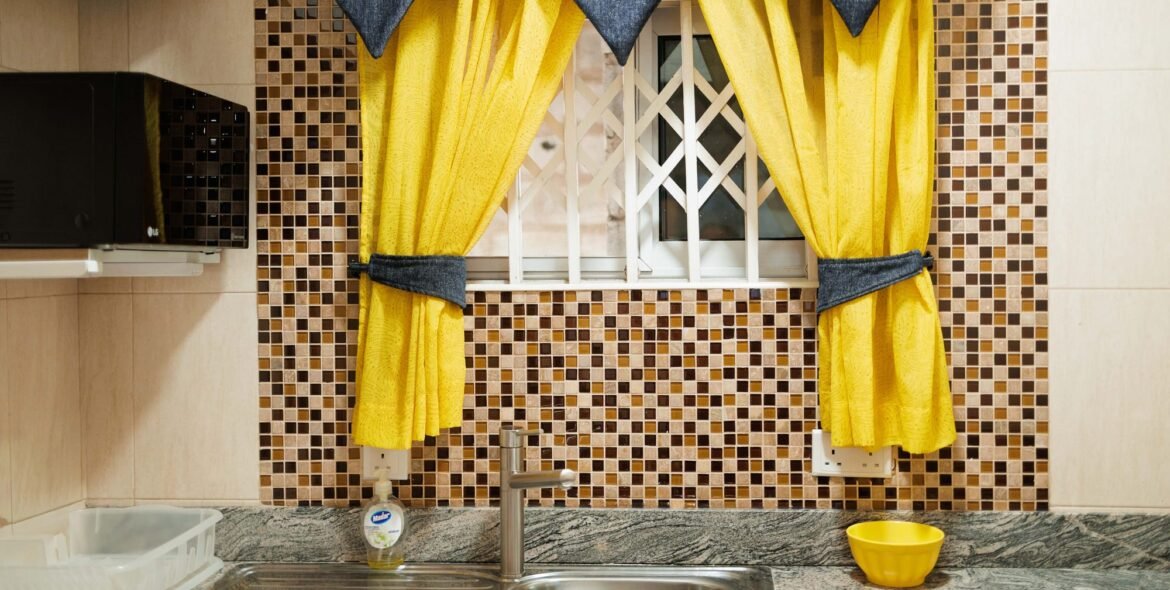 Kitchenette window with yellow curtains