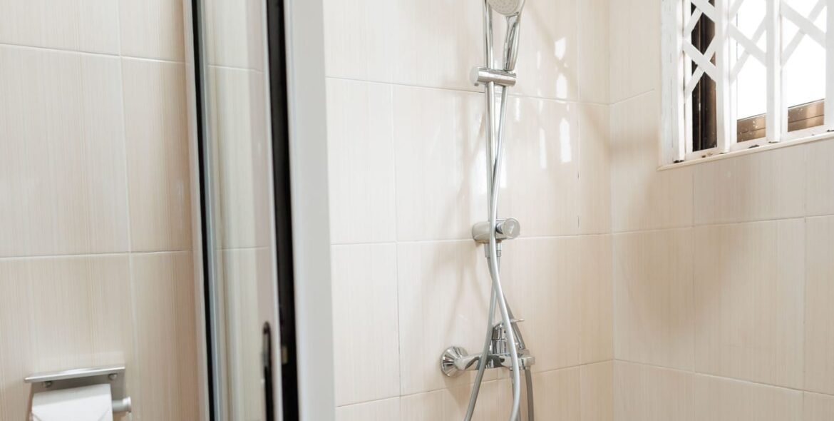Shower enclosure and shower head in a private bathroom