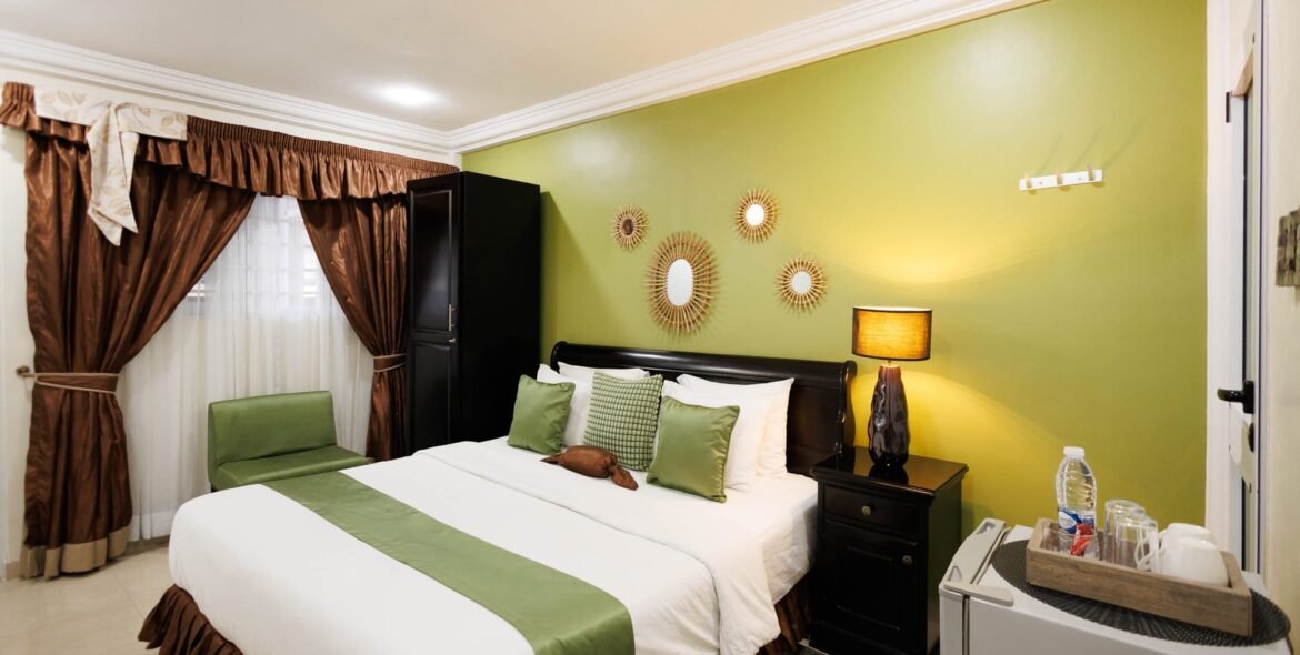 Side view of a queen room with green decor