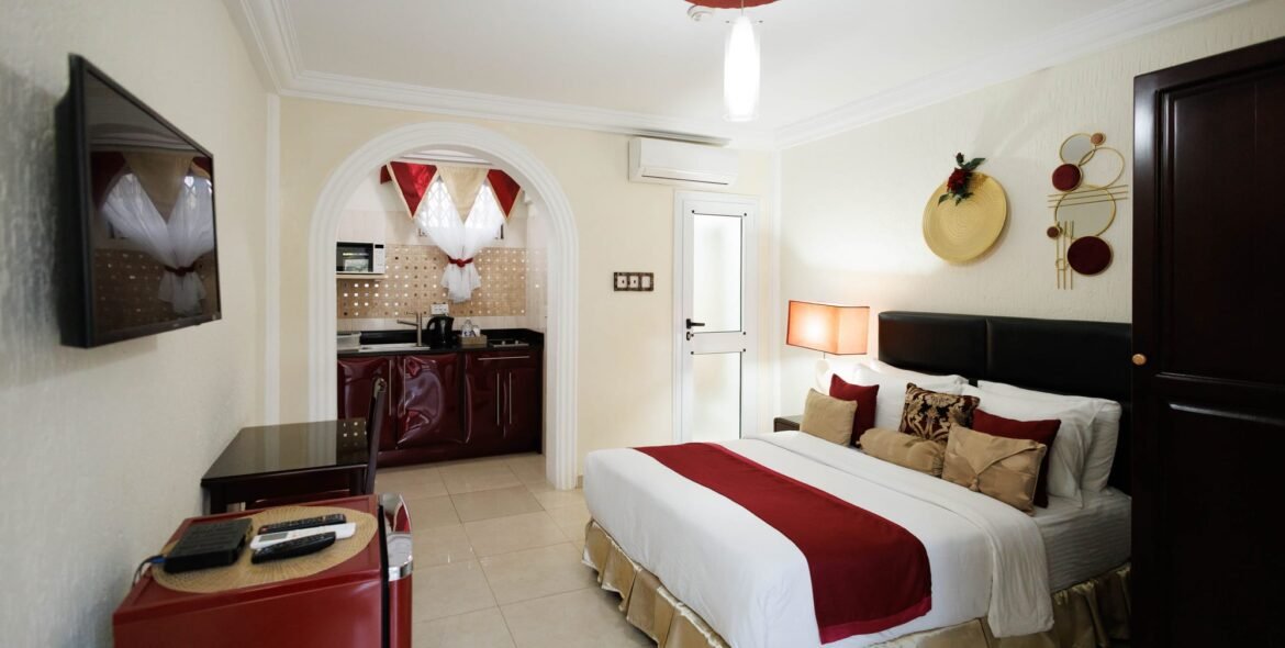 Standard Double Room with a double bed, seating and kitchenette at The Ritzz Exclusive in Osu