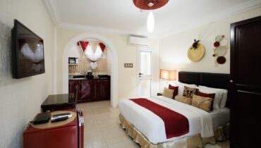 Standard Double Room with a double bed, seating and kitchenette at The Ritzz Exclusive in Osu