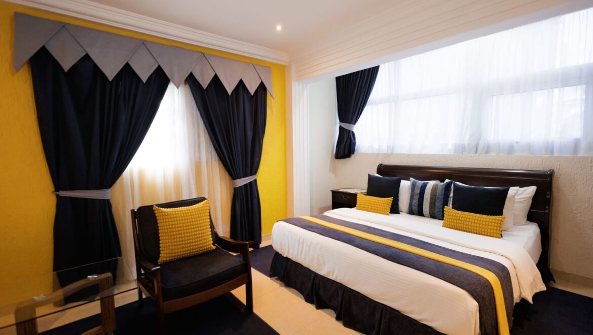 Side view of a queen room with a yellow accent wall